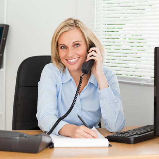 Employee on phone smiling at camera